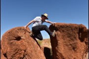 Climbing up for a shot at the Devils Marbles